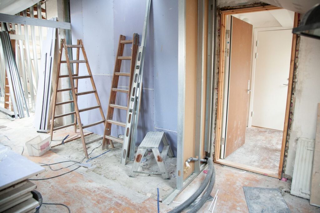Construction site featuring ladders and tools in a home renovation setting
