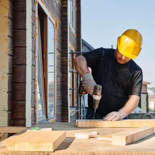 Man in Black Shirt Holding Black Power Tool